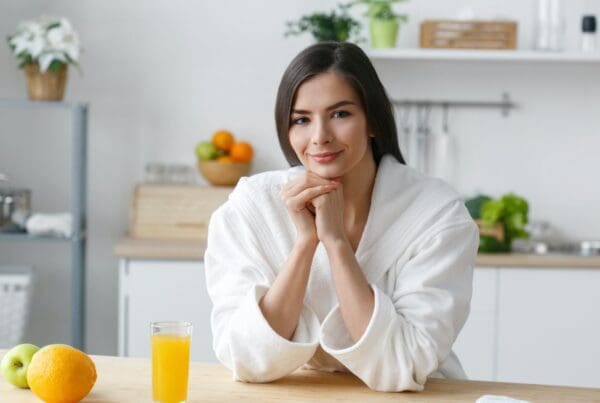 Woman on kitchen home with green vegetables cooking. Helthy home food diet vitamins.